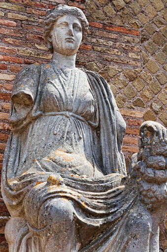 Portrait of Roman goddess Fortuna Annonaria statue, located at the domus of Fortuna Annonaria situated in ancient Roman village ruins of ancient Ostia in Rome