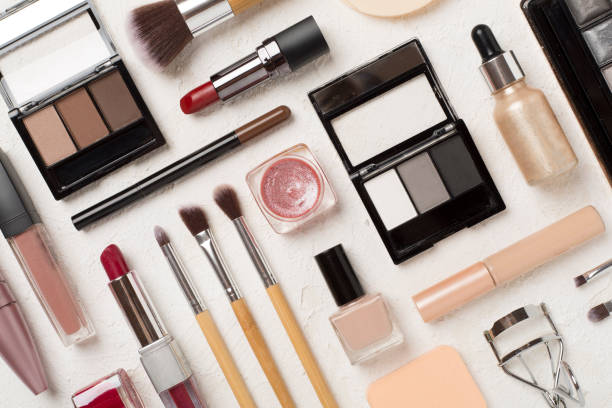 istock Flat lay with makeup products and tools on concrete background 1870579911