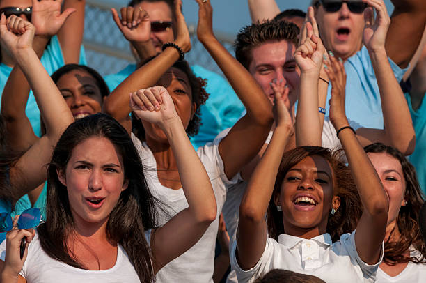 istock Fans with raised arms cheering for their team 187058123
