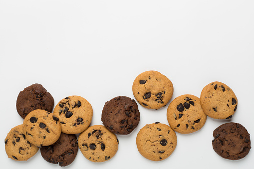 Flat lay with chocolate chip cookies on white background