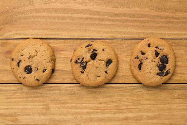 istock Flat lay with chocolate chip cookies on wooden background 1870581459