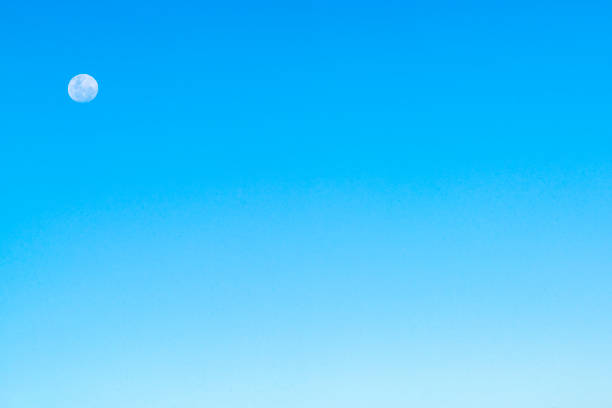 istock Full moon during the day on blue sky backgrounds 1870585608