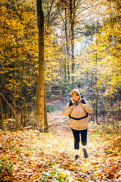 istock Single middle-aged woman hiking in the fall 187059027