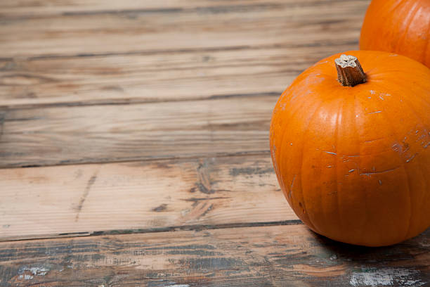 istock Pumpkins against wooden background 187059122