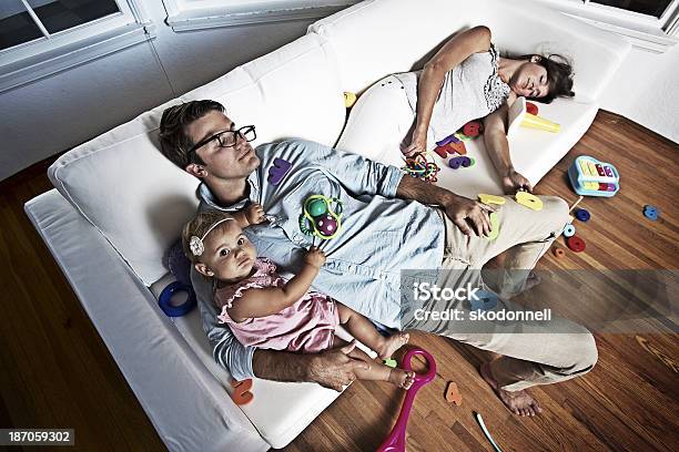 Baby Girl On A Messy Couch With Her Parents Stock Photo - Download Image Now - Chaos, Family, Messy