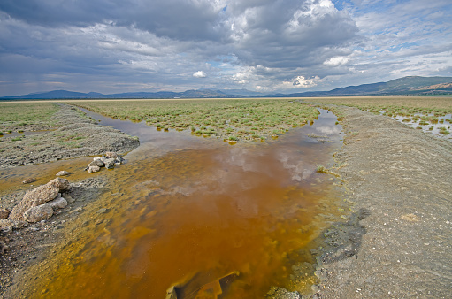 Polluted water into Lake Burdur. Cloudy sky.