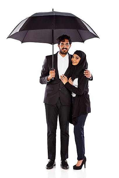 istock Romantic young couple standing together under umbrella 187061570