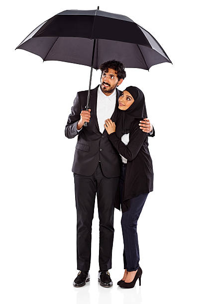 istock Young couple under umbrella checking for rain 187061760