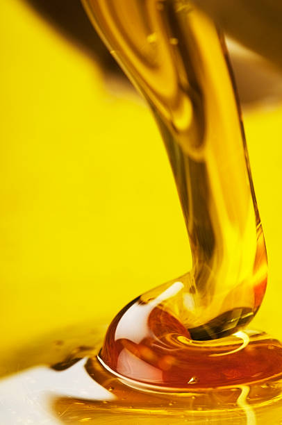 istock Golden honey pouring down into a yellow bowl 187061856