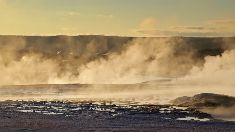 Scenic Shot of Steam Blowing Off of Geysers in Yellowstone National Park at Sunset