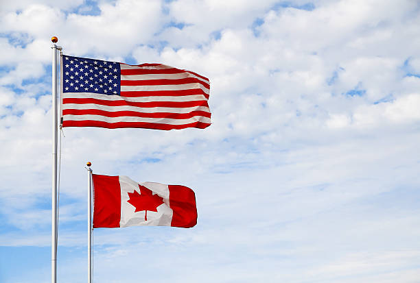 istock Canadian and US flags flying together 187062260