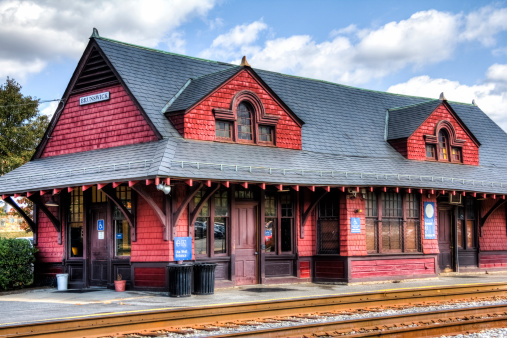 A High Dynamic Range (HDR) rendition of the old wood sided railroad station in Brunswick Maryland.  Beautiful cloud filled blue sky enhances the old station.