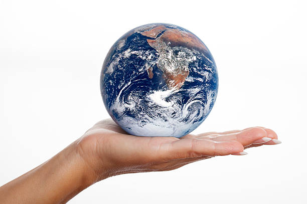 istock Globe earth glass ball in human hand isolated on white 187063055