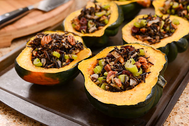 Acorn Squash Stuffed with Wild Rice Acorn Squash Stuffed with Wild Rice, Pecan, and Cranberry stuffed stock pictures, royalty-free photos & images