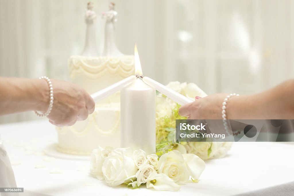 レズビアンの同一性結婚を控えた花嫁の照明キャンドルのウェディングケーキ - 2人のロイヤリティフリーストックフォト