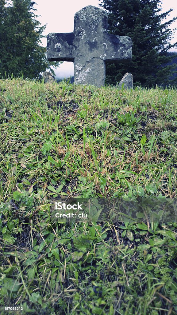 Atoning cross Seen in MIttelberg, Austria. A medieval murderer of two people had to build this atoning cross close to the church. The smaller stones symbolize those two victims. Austria Stock Photo