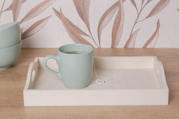 istock Green ceramic tea mug on the wooden tray in the kitchen 1870661194