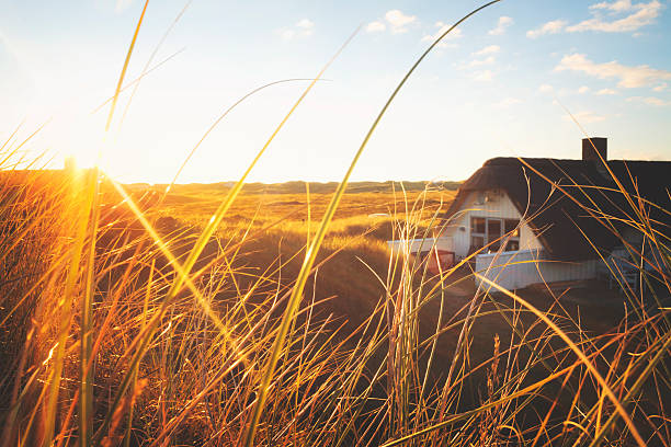 Dune with little holiday home stock photo