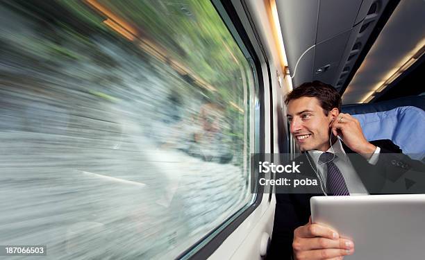 Bussinesman Sitzgelegenheiten Auf Einen Zug Lisenig Musik Trog Digitale Tisch Stockfoto und mehr Bilder von Blick durchs Fenster