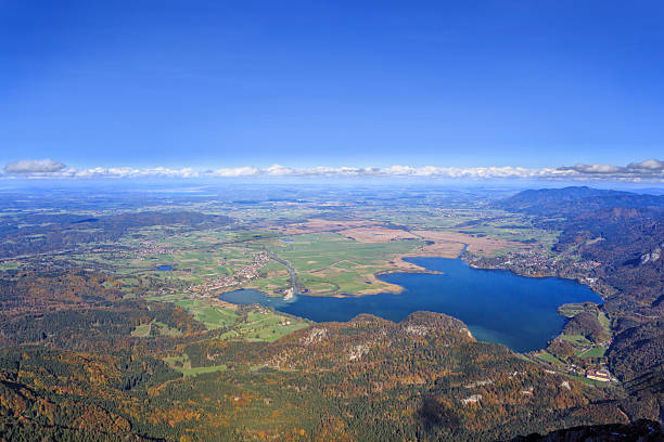 Looking down from mountain Herzogstand to Lake Kochel / Kochelsee at the foothills of th e European alps. In the background at the horizon the lakes Ammersee and Starnberg Lake.