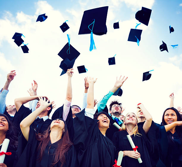 выпускной caps thrown in the air» - graduation adult student mortar board student стоковые фото и изображения