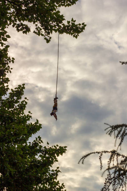 istock A man tied to a rope upside down doing bungee jump 1870670511
