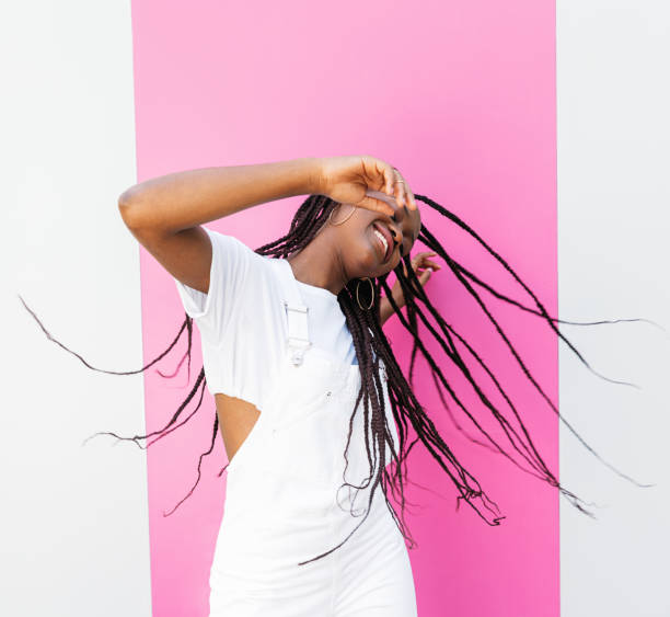 istock Stylish girl in white clothes having fun and dancing 1870670516