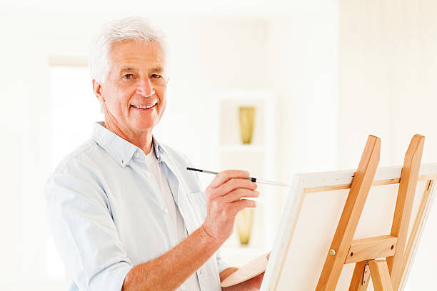 istock Happy Senior Man Painting On Canvas 187067276