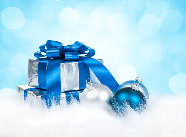 istock Christmas gift and baubles against defocused blue lights 187068206