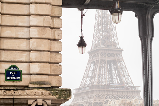 The Eiffel Tower from the Bir Hakeim bridge in the rain at the start of winter - Paris, France