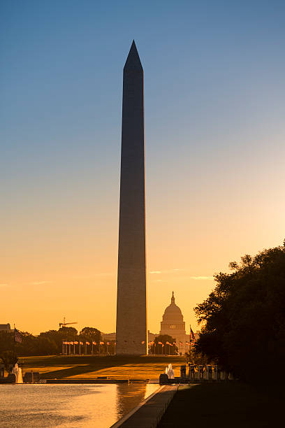 Washington Monument from the Lincoln Memorial Washington DC Monument and the US Capitol Building and grounds viewed across the reflecting pool from the Lincoln Memorial on The National Mall USA washington monument washington dc stock pictures, royalty-free photos & images