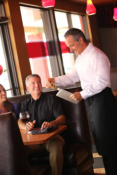 istock Couple With Waiter Swiping Credit Card On Tablet Computer 187068601