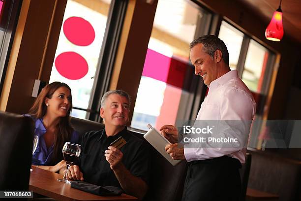 Happy Couple Paying By Credit Card In Restaurant Stock Photo - Download Image Now - Credit Card, Mature Couple, Paying