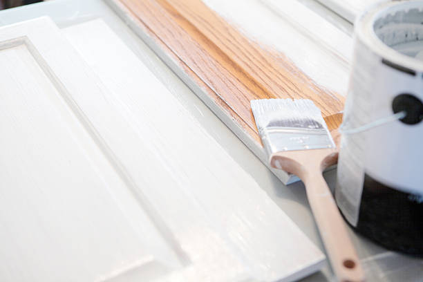 Painting Kitchen Cabinets Close up of painting kitchen cabinets white. cupboard stock pictures, royalty-free photos & images