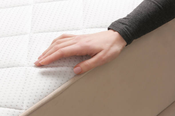 istock Woman press on comfortable mattress, checking and testing quality 1870688038