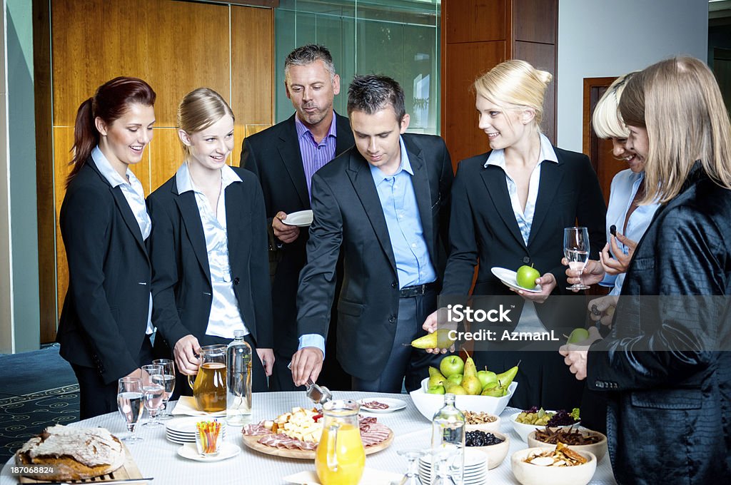 Business team having a buffet lunch Group of business people having a buffet lunch outside the conference room in a hotel. Party - Social Event Stock Photo