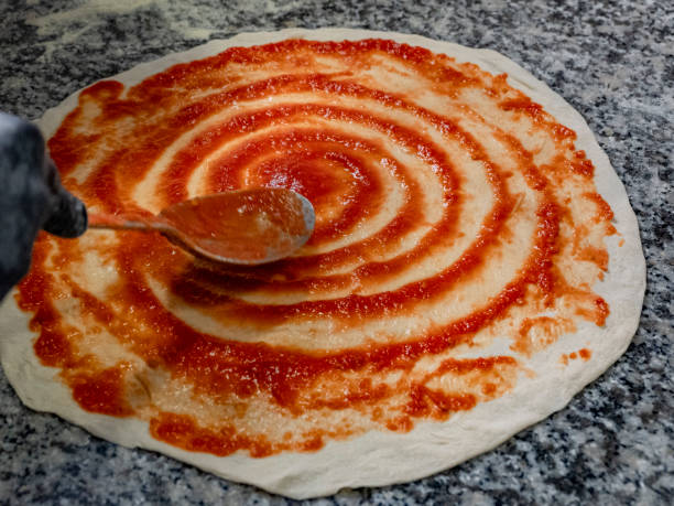 istock Season the pizza 1870689146