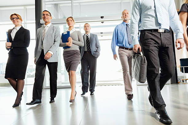 istock Group of successful businesspeople walking into the building. 187068938