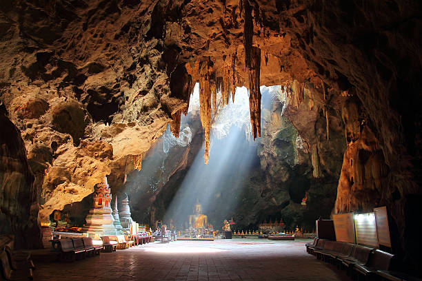 golden Buddha in Thai cave stock photo
