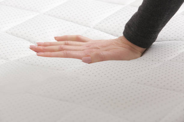 istock Woman press on comfortable mattress, checking and testing quality 1870694905