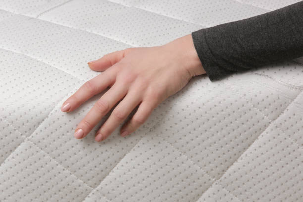 istock Woman press on comfortable mattress, checking and testing quality 1870696566