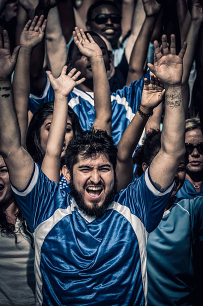 istock Fans with raised arms cheering for their team 187069779