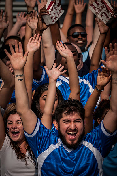 istock Fans with raised arms cheering for their team 187069804