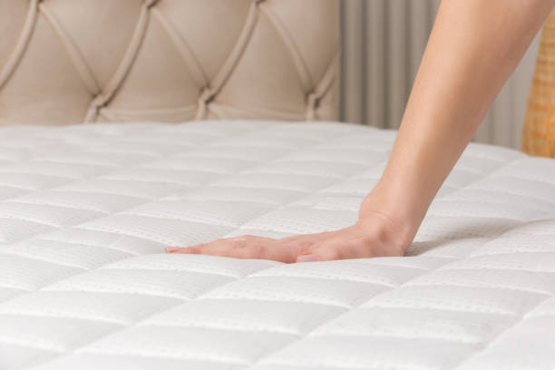 istock Woman press on comfortable mattress, checking and testing quality 1870699694