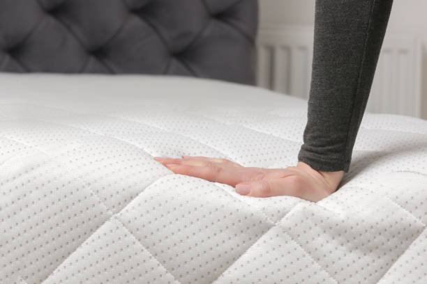 istock Woman press on comfortable mattress, checking and testing quality 1870701759