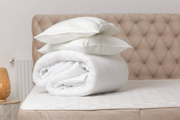 istock Soft folded duvet and pillows on bed 1870703074