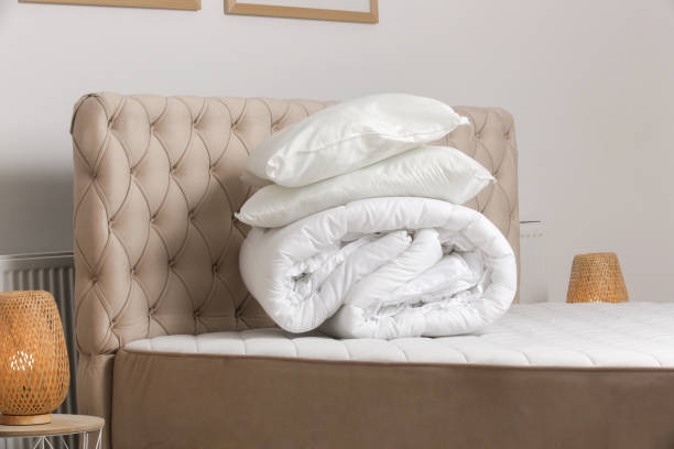 istock Soft folded duvet and pillows on bed 1870705159