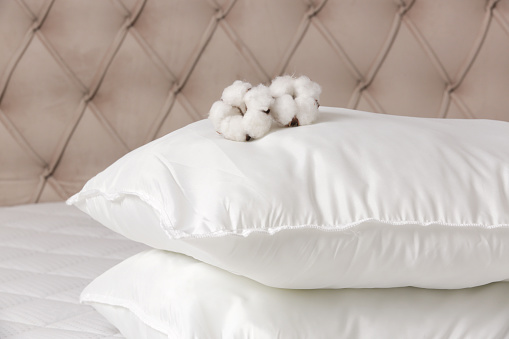 Soft comfortable white pillows on a bed