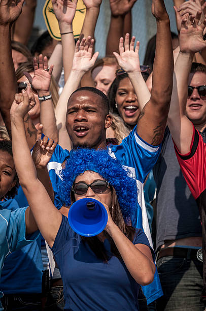 istock Fans with raised arms cheering for their team 187070847