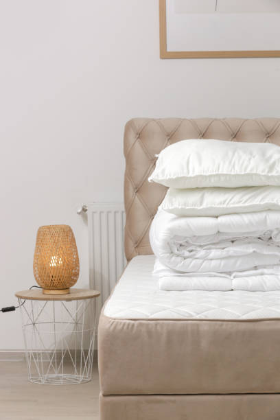 istock Soft folded duvet and pillows on bed 1870709327